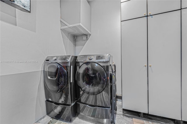 washroom featuring washing machine and clothes dryer and wood-type flooring