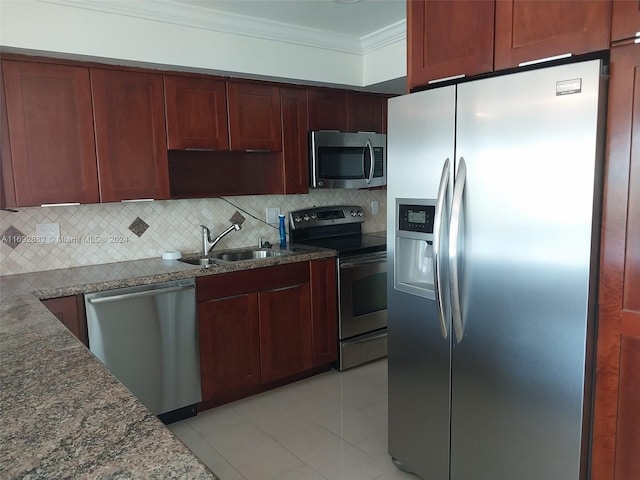 kitchen with light tile patterned flooring, sink, appliances with stainless steel finishes, ornamental molding, and decorative backsplash