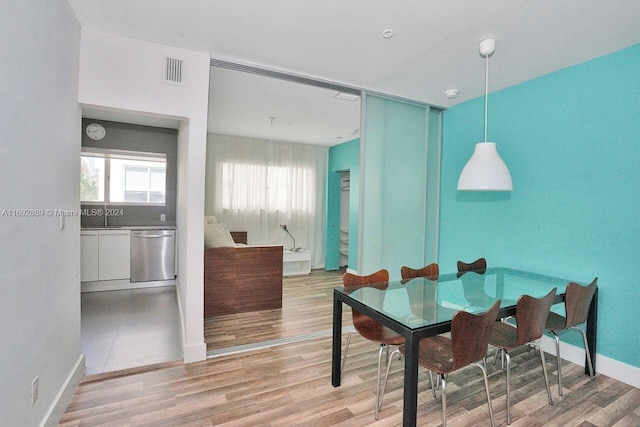 dining room with sink and wood-type flooring