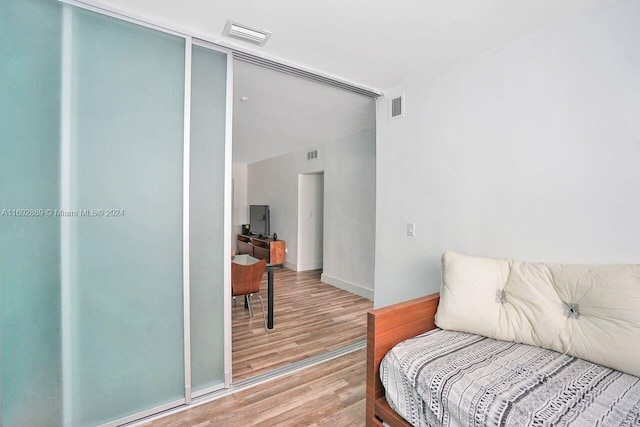 bedroom with hardwood / wood-style flooring