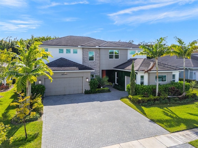 view of front of house with a garage and a front yard