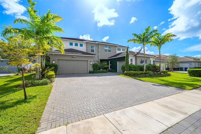 view of front facade with a garage and a front lawn