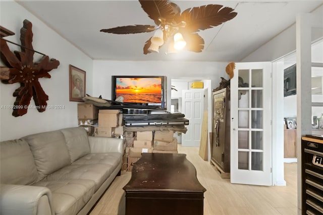 living room with ceiling fan and light wood-type flooring