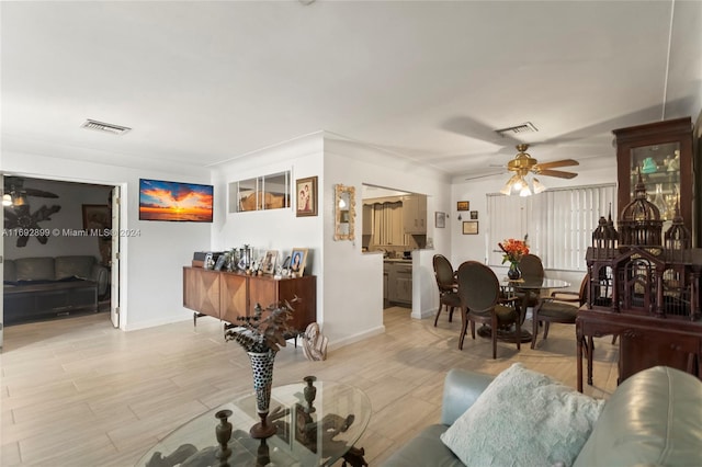 living room featuring light hardwood / wood-style flooring and ceiling fan