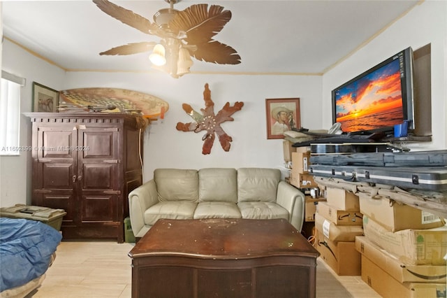 living room with ceiling fan and ornamental molding