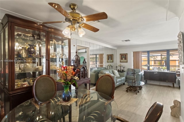 dining space with ceiling fan and a wall mounted air conditioner