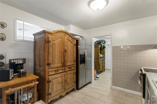 kitchen with tile walls and appliances with stainless steel finishes