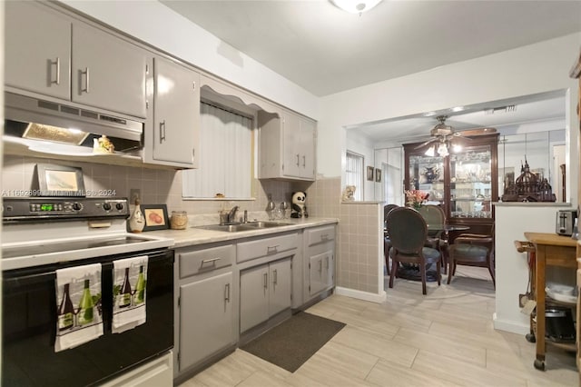 kitchen featuring range with electric cooktop, tasteful backsplash, ceiling fan, sink, and gray cabinets