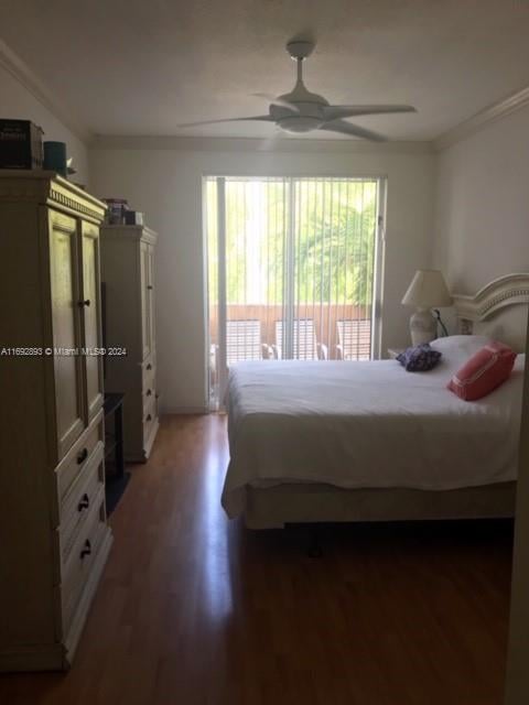 bedroom with access to exterior, dark hardwood / wood-style flooring, ornamental molding, and ceiling fan