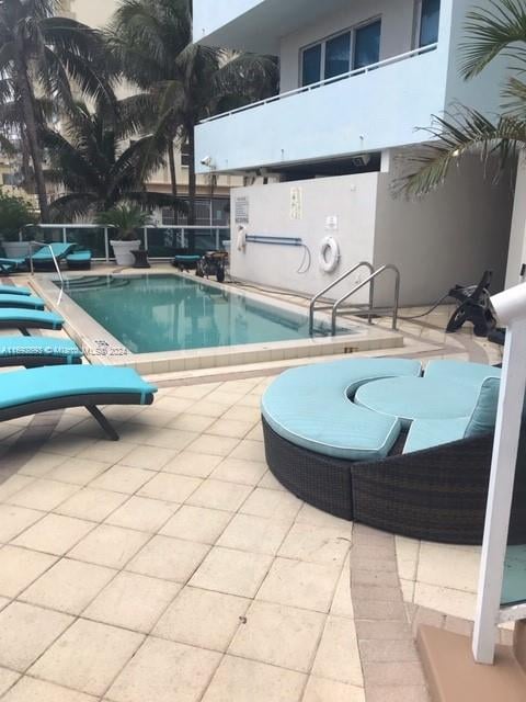 view of swimming pool with a patio