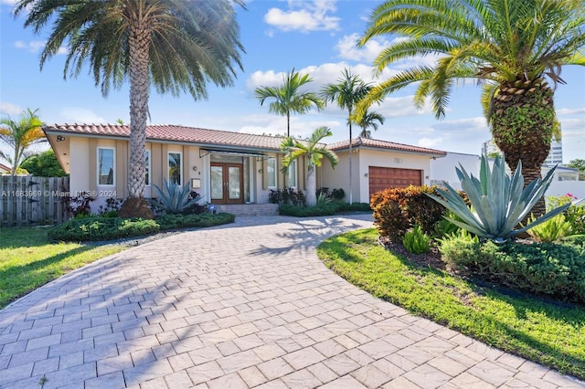 mediterranean / spanish-style home with french doors and a garage