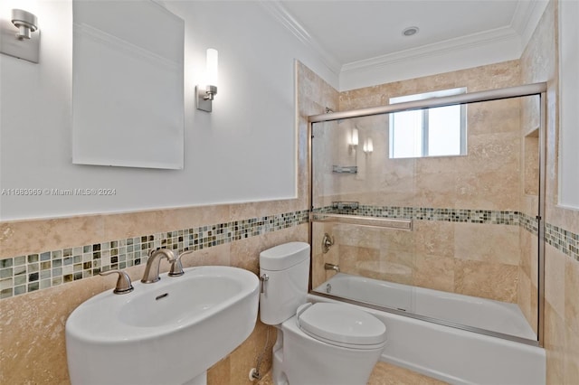 full bathroom featuring enclosed tub / shower combo, toilet, tile walls, sink, and ornamental molding