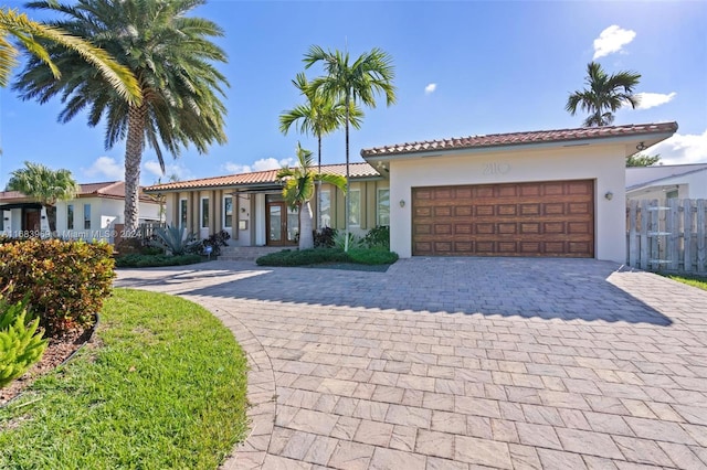 mediterranean / spanish-style home with a garage