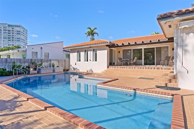 view of swimming pool with a patio area