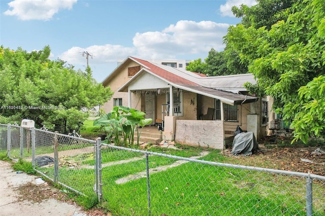 bungalow-style house featuring a front lawn