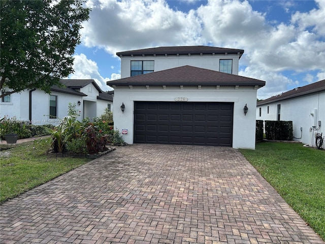 view of front of house featuring a garage and a front lawn