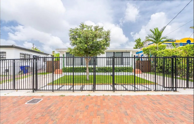 view of gate with a yard