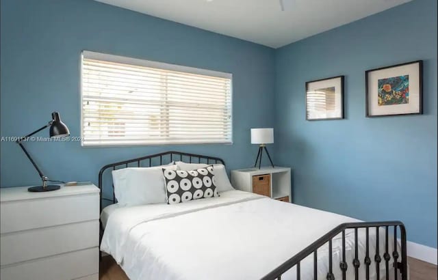 bedroom with hardwood / wood-style flooring