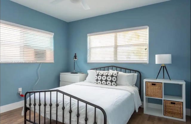 bedroom with hardwood / wood-style floors and ceiling fan