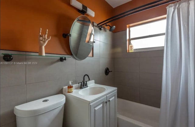 full bathroom featuring tile walls, vanity, toilet, and shower / bathtub combination with curtain