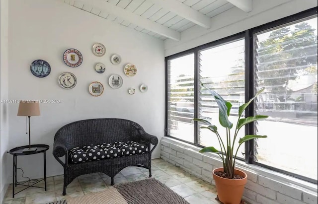 living area with beamed ceiling and wood ceiling