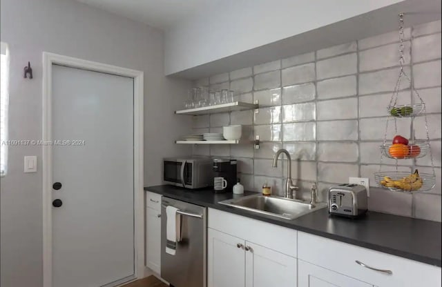 kitchen featuring white cabinetry, sink, backsplash, and stainless steel appliances