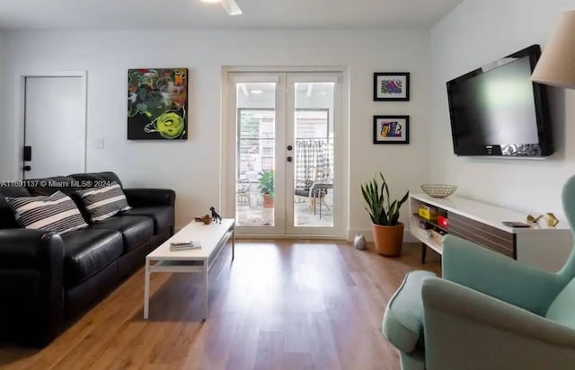 living room with french doors and light hardwood / wood-style flooring