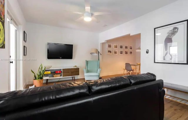 living room featuring hardwood / wood-style floors and ceiling fan