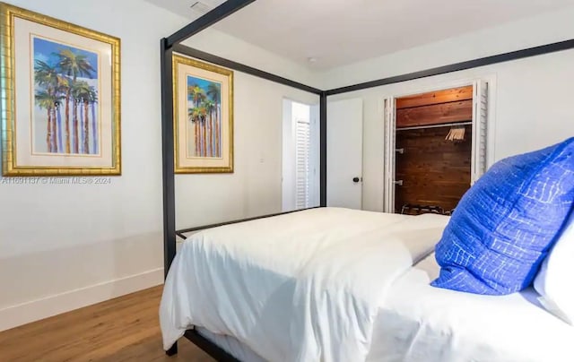 bedroom with wood-type flooring and a closet