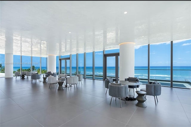 community lobby featuring a water view and a view of the beach