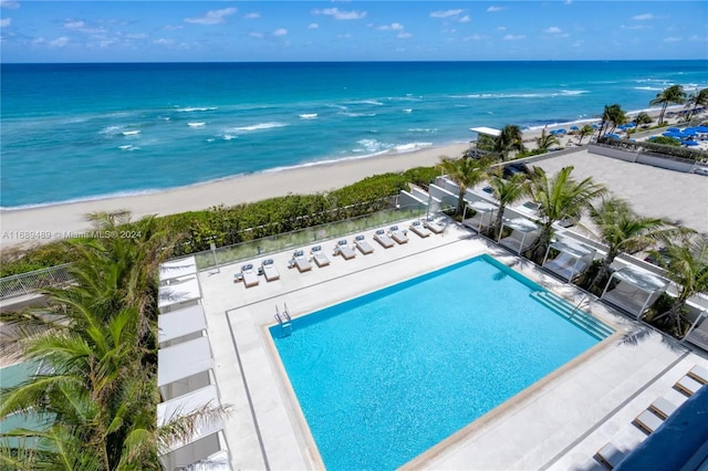 drone / aerial view featuring a water view and a beach view