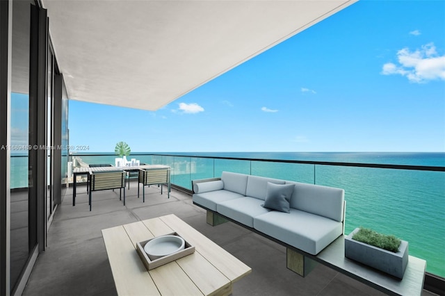 balcony featuring an outdoor living space and a water view