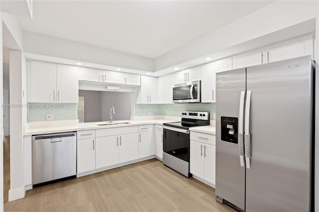 kitchen featuring white cabinets, light hardwood / wood-style floors, sink, and stainless steel appliances