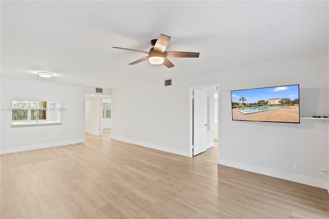 unfurnished living room with light hardwood / wood-style flooring and ceiling fan