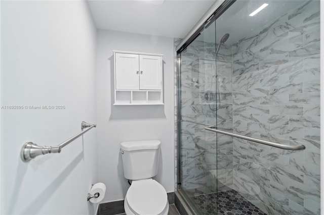 bathroom with an enclosed shower and toilet