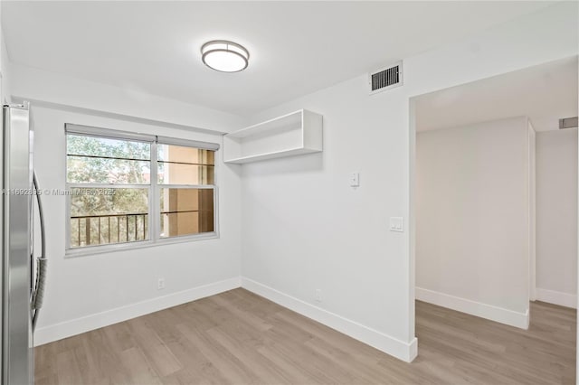 unfurnished room with light hardwood / wood-style flooring