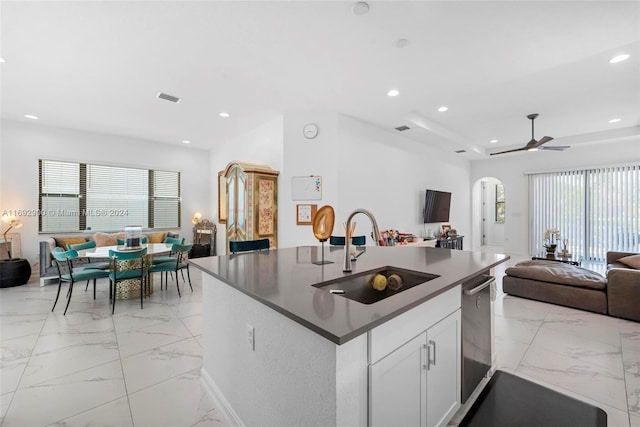 kitchen with white cabinets, a kitchen island with sink, sink, and plenty of natural light