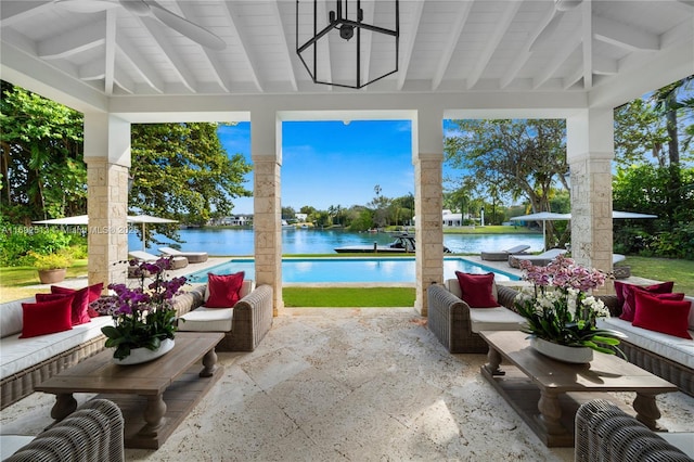 sunroom / solarium with beamed ceiling and a water view