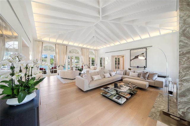 sunroom with lofted ceiling with beams and french doors