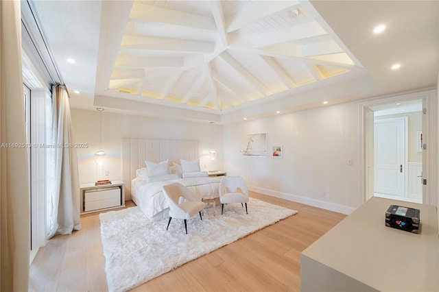 bedroom with vaulted ceiling with beams and light wood-type flooring