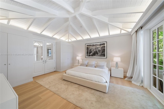 bedroom with wood-type flooring, lofted ceiling with beams, french doors, and wooden ceiling