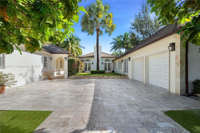 mediterranean / spanish-style house with a garage