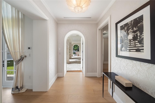 hallway featuring crown molding and light hardwood / wood-style flooring