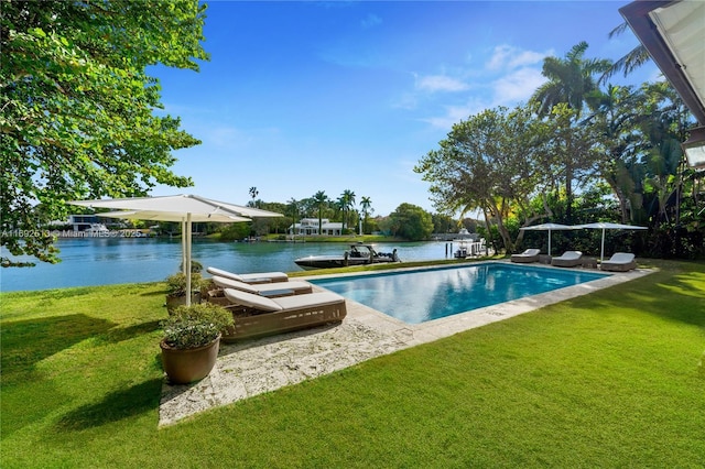 view of swimming pool with a water view and a lawn