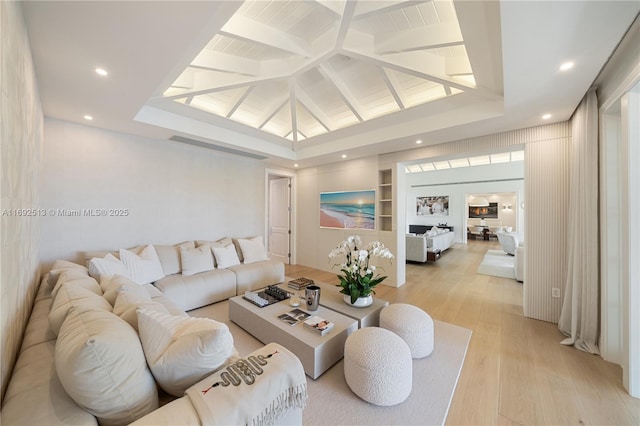 living room featuring built in shelves and light hardwood / wood-style flooring