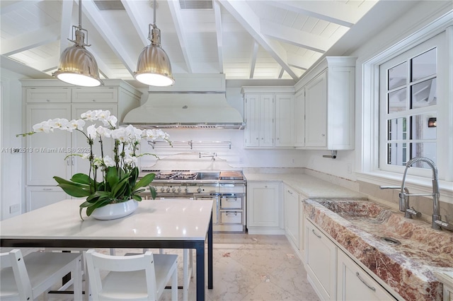 kitchen featuring vaulted ceiling with beams, hanging light fixtures, double oven range, custom range hood, and white cabinets