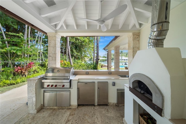 view of patio featuring exterior kitchen, grilling area, and ceiling fan