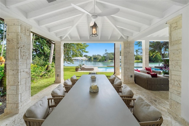 view of patio / terrace featuring a water view, ceiling fan, and an outdoor hangout area