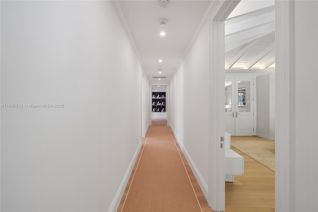 hall featuring crown molding and light hardwood / wood-style floors