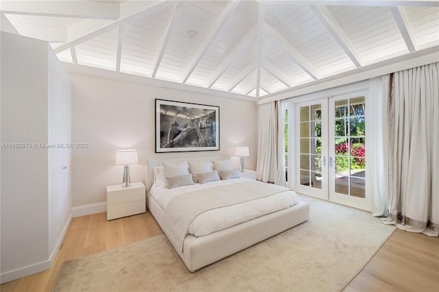 bedroom featuring vaulted ceiling with beams, hardwood / wood-style floors, french doors, and access to outside